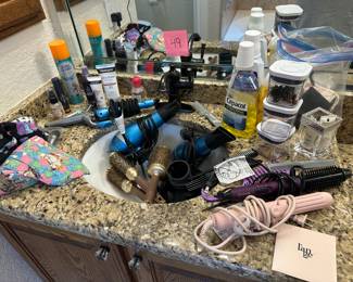Lot 49  lot of curling irons, hairdryers, and miscellaneous bathroom products. $35 