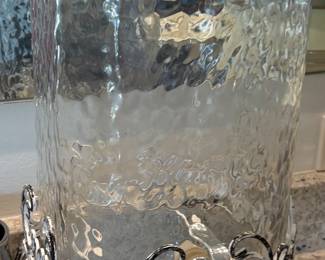Large glass drink dispenser on metal stand 