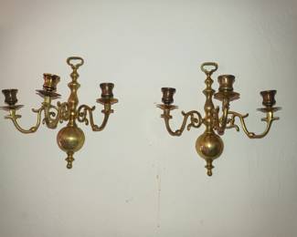 Minimalist brass candle sconces that look like they are dancing