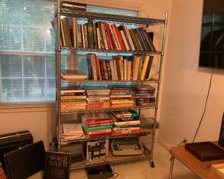 Gun Digest books, 8mm film projector,typewriter, metal shelf