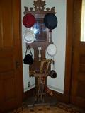 Walnut hall tree, eastlake style with mirror and single drip pan. Vintage hats, purses, and a top hat.