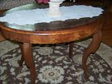 Oval burled walnut table with leather insert.