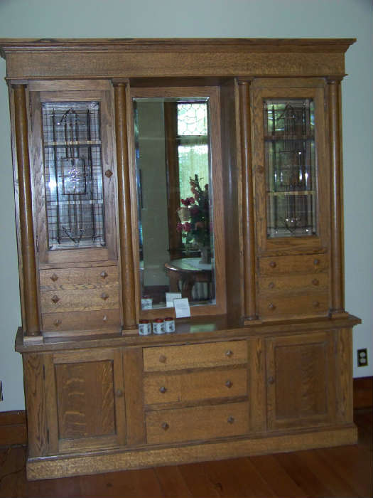 Quartersawn oak huge buffet with beveled cut glass doors and center beveled mirror.  Circa 1920.