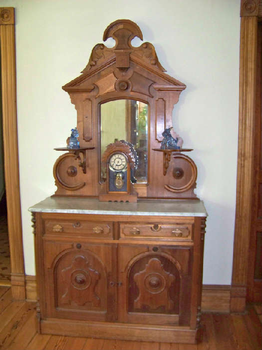 Walnut sideboard with white marble top and beveled mirror.  Beautiful carving.  Circa 1870.