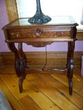Burled walnut parlor table with glass insert and one drawer.