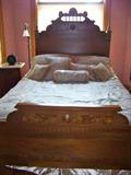 Walnut bed with carving. Burled accents. Converted to queen size.