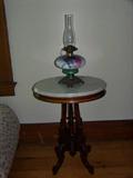 Walnut oval parlor table with marble top. Beautiful painted kerosene lamp.