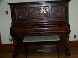 Mahogany piano with claw feet and great carving. Plays well.