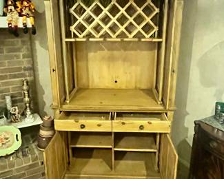 OPENED UP: TOP - POCKET DOORS w/ WINE RACK INSIDE. BOTTOM: TWO DRAWERS & ENCLOSED STORAGE.