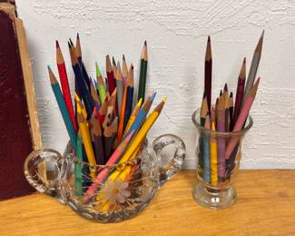 Cut glass sugar bowl and more filled with sharpened colored pencils 
