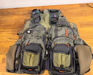 Fabulous multi pocketed fishing vest includes some flies