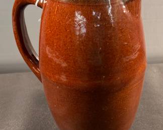Brown pitcher with green rim