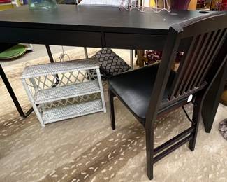 Dark wood writing desk, chair, white wicker shelf