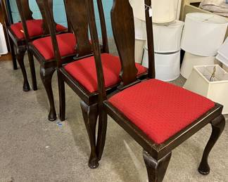 Four dining chairs with red cushions