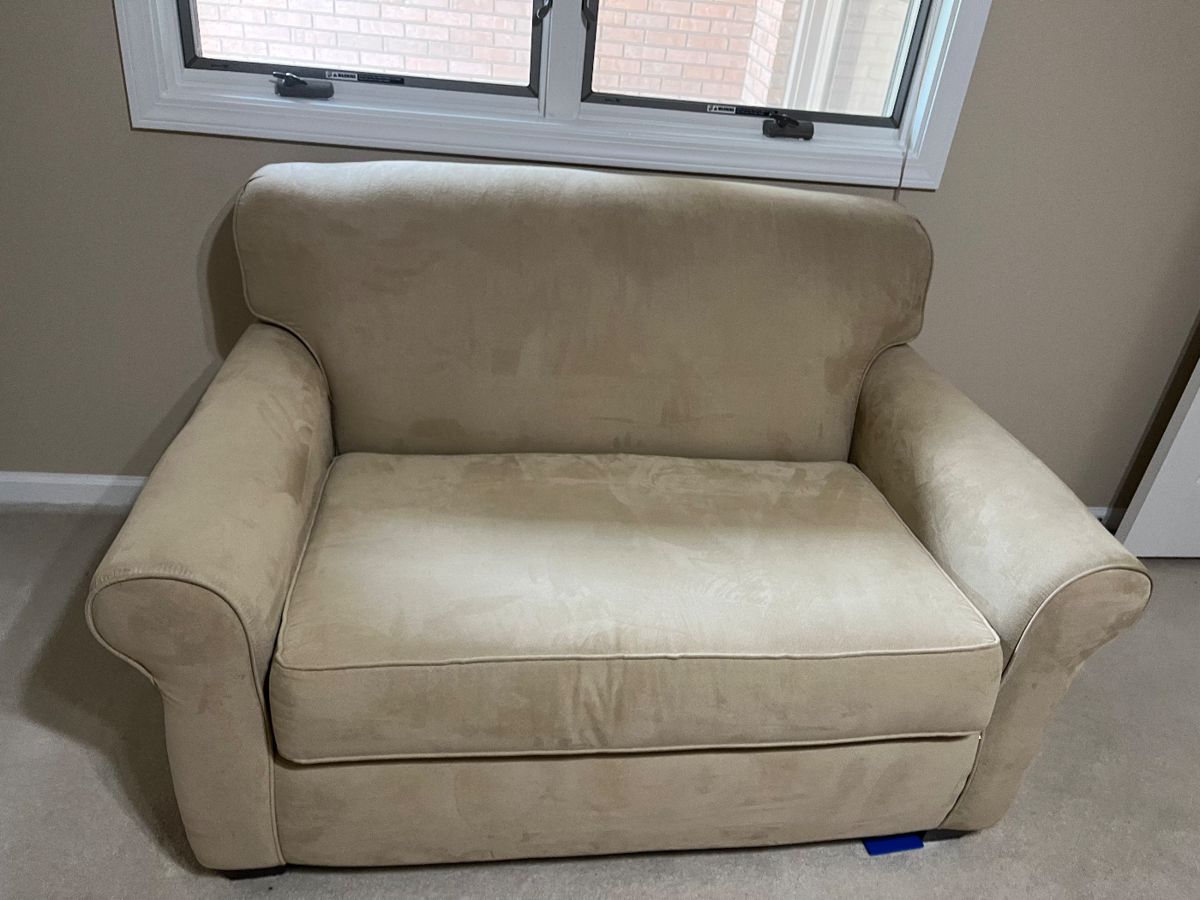 LIKE NEW HIDE-A-BED COUCH. MATTRESS STILL IN PLASTIC