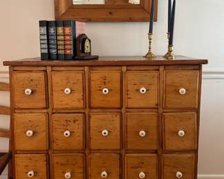 Antique Pine 20-Drawer Apothecary Cabinet. Measures 36" W x 18" D x 35" H. Pictured with Antique Pine Mirror. Measures 25" W x 18.5" H.