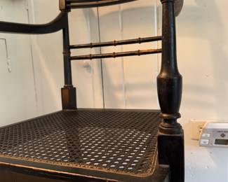 Antique Ebonized Wood Regency Style Arm Chair with Parcel Gilt Detailing and Cane Seat. Photo 2 of 8.