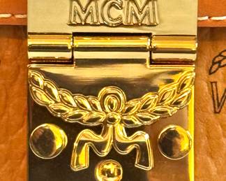MCM Logo Hardware Detail – Gold Push-Lock Clasp with Signature Laurel Emblem