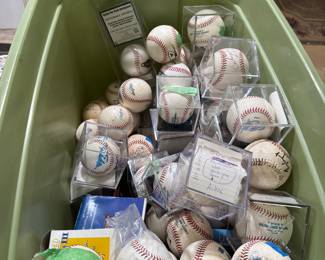 living room middle on table. dozens of signed balls.