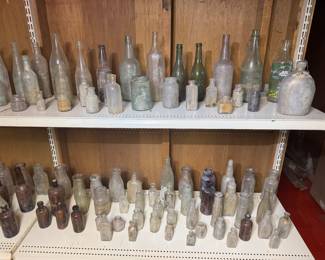 basement middle room. dozens of as found bottles. many embossed. 