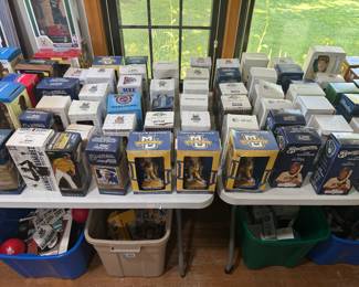 100's of bobbleheads. living room west wall on table, in bins under table too.