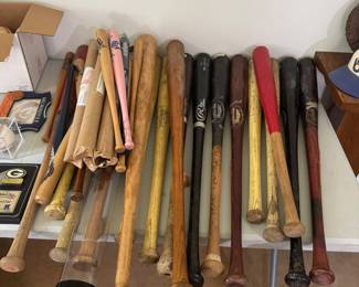 living room N wall on table. Game used bats. 