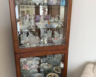 Loaded display cabinet filled with antiques and vintage kitsch 