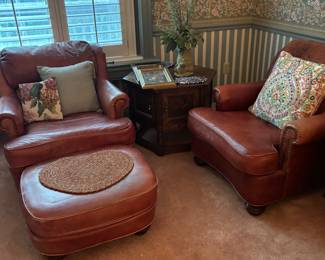 2 Beautiful rust color leather arm chairs with ottomans. Good condition.