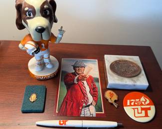 UT memorabilia including Smokey bobblehead, pins, marble paperweight and pen with postcard of Paul "Bear" Bryant, football coach for the University of Alabama Crimson Tide