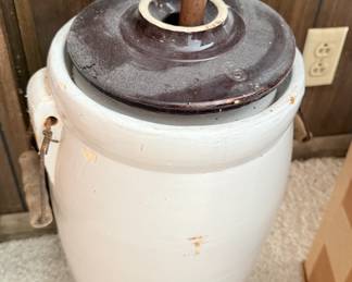 Antique stoneware butter churn with a lid and a wooden dasher