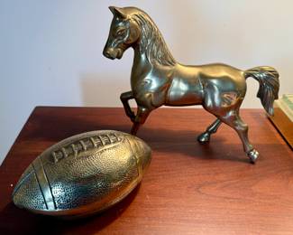 Brass horse and football statues
