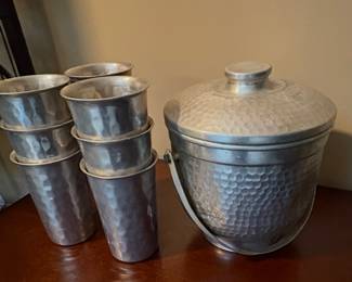 vintage hammered aluminum ice bucket with matching tumblers.