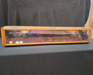 Shadow box with an antique golf club. 