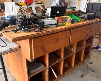 Garage is packed with tools and a large workbench