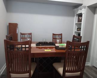 Gorgeous dinning table with 6 chairs with wine and drawer storage.
