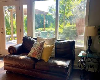 LEATHER SOFA-HAS SCRATCHES, DECORATOR PILLOWS, WROUGHT IRON GLASS-TOP TABLE