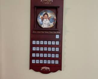 R52 - $50. Sandra Kuck "Always With You" Calendar. Includes wooden framed calendar with days & 12 plates with storage box. Calendar measures 10" wide x 26" tall. 