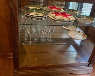 R3 - $225. Howard Miller Lighted Display Cabinet.  Door slides across the front and has a key to lock. Measures 42" at the widest point x 15" deep x 80.5" tall. 