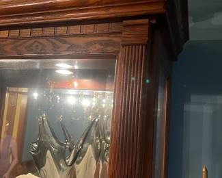 R3 - $225. Howard Miller Lighted Display Cabinet.  Door slides across the front and has a key to lock. Measures 42" at the widest point x 15" deep x 80.5" tall. 