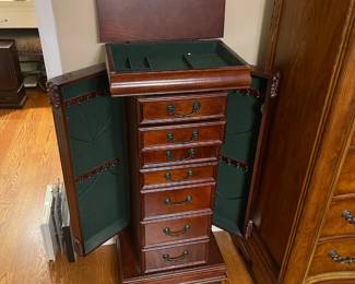 R49 - $100. Stand up Jewelry Box. Measures 18" wide x 12.5" deep x 42" tall. Sides open for necklaces. Drawers all slide. Mirrored top lifts up. In very good condition!
