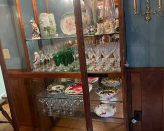 R3 - $225. Howard Miller Lighted Display Cabinet.  Door slides across the front and has a key to lock. Measures 42" at the widest point x 15" deep x 80.5" tall. 