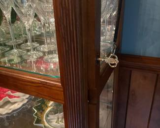 R3 - $225. Howard Miller Lighted Display Cabinet.  Door slides across the front and has a key to lock. Measures 42" at the widest point x 15" deep x 80.5" tall. 