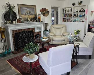 Side chairs in neutral color, floor rug, and several occasional tables to fit any decor.