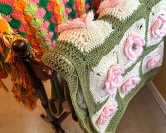 beautiful hand crocheted Afghans and a quilt rack