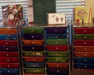 Rolling Organizers With Plastic Drawers Filled With Craft Supplies And Wooden Cabinet
