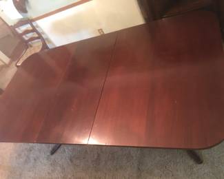 PRE-SALE NOW 1940’s-1950’s Mahogany Duncan Phyfe Rectangle Dining Table is 79.5 inches long (with one leaf that is 18 inches) by 42 inches wide and 29 inches tall. Table has twin 3 legged pedestal bases with traditional brass cap feet. Includes 6 matching chairs. The chairs are in very good condition with Famous Barr Labels. The table has a few scratches but it’s in good condition and has pads. Separate the 6 Chairs are $175 or Just the Table is $175, OR the Table & Chairs Together as a Set Only $300.