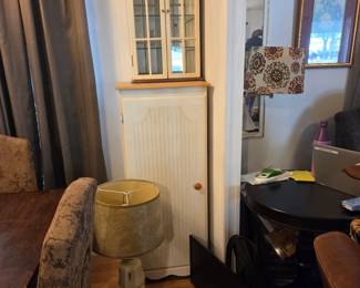 Storage furniture (display, pantry), Lamp, Table-top music player, wall decor.