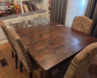 Medium side wooden dining table 42"W x 60"D with 4 upholstered chairs. 