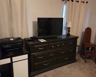 Large wooden dresser (7 drawers) 62"W, small desk with storage, antique ironing chair, 32" TV (not a smart TV), printer, dvd player, lamp. 