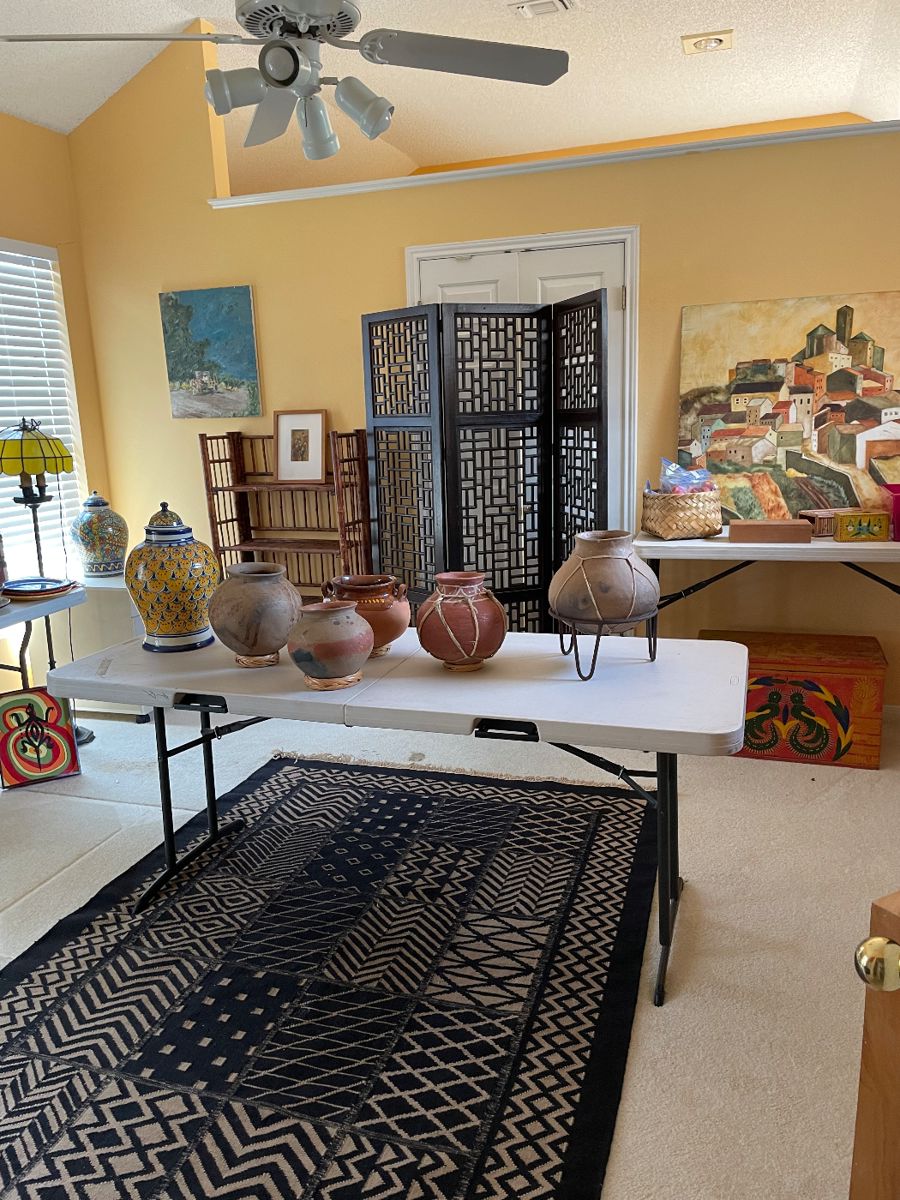 Several large pottery pots are Copper Canyon.  Rug is Bogolan Mud Cloth Fabric. 5 x 5 . Hand made African textile. Three panel screen